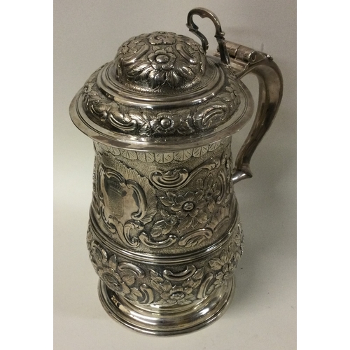 510 - A George III chased crested silver lidded tankard with French Marquis crest to centre. London 1762. ... 