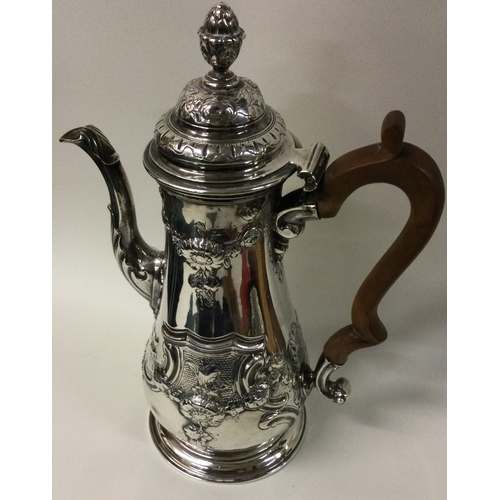 511 - A large 18th Century George III chased silver coffee pot. London 1759. Approx. 872 grams. Est. £800 ... 