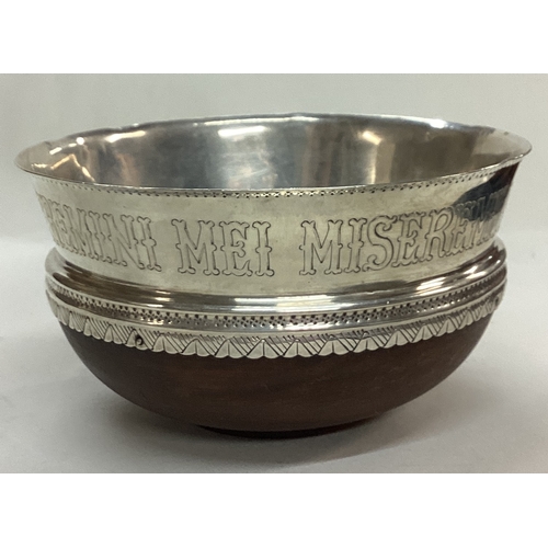 58 - An Arts and Crafts silver and wooden bowl. Inscribed MISEREMINI MEI SALTEM AMICI MEI. Sheffield 1927... 