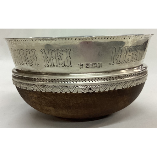 58 - An Arts and Crafts silver and wooden bowl. Inscribed MISEREMINI MEI SALTEM AMICI MEI. Sheffield 1927... 