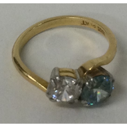 584 - A good diamond and zircon two stone crossover ring in 18 carat gold setting. Approx. 4 grams. Est. £... 