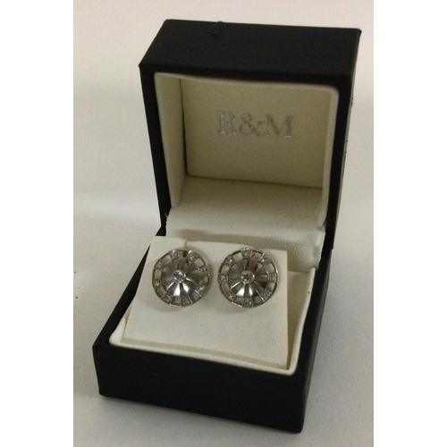 597 - A pair of unusual two colour gold cufflinks in the form of dart boards with diamond mounts. Approx. ... 