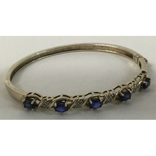 598D - A silver stone set bracelet with concealed clasp. Approx. 15.7 grams. Est. £20 - £30.