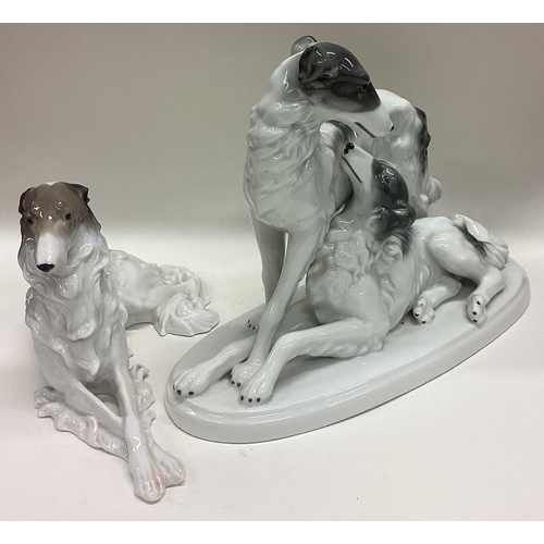 603 - A pair of porcelain figures of dogs. Est. £20 - £30.