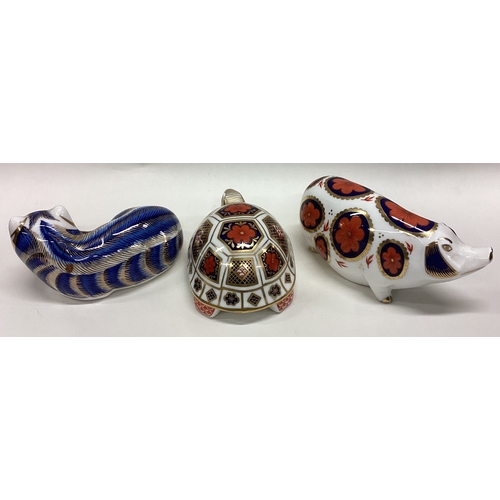 607 - A Royal Crown Derby figure of a tortoise together with two others. Est. £20 - £30.