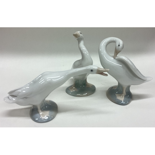 609 - Three Lladro figures of geese in standing position. Est. £20 - £30.