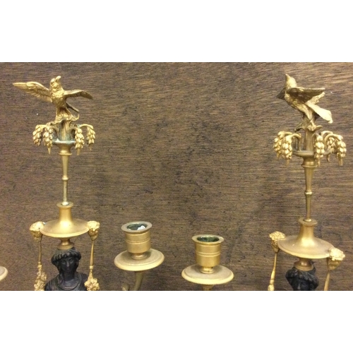 639 - A fine pair of bronze candlesticks in the form of figures with swag decoration and bird finials. Est... 