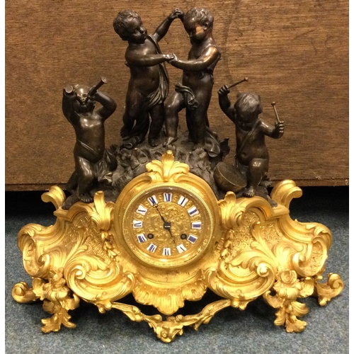 640 - A good French bronze mantle clock heavily decorated with scrolls with gilt dial. Est. £150 - £200.