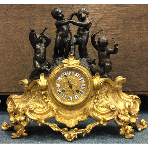 640 - A good French bronze mantle clock heavily decorated with scrolls with gilt dial. Est. £150 - £200.