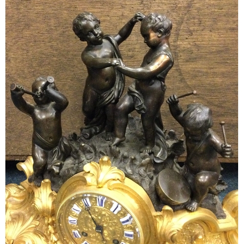 640 - A good French bronze mantle clock heavily decorated with scrolls with gilt dial. Est. £150 - £200.