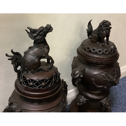 641 - A good matched pair of bronze censers on stands with lift off covers decorated with animals. Est. £4... 