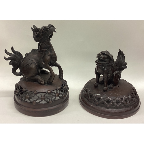 641 - A good matched pair of bronze censers on stands with lift off covers decorated with animals. Est. £4... 