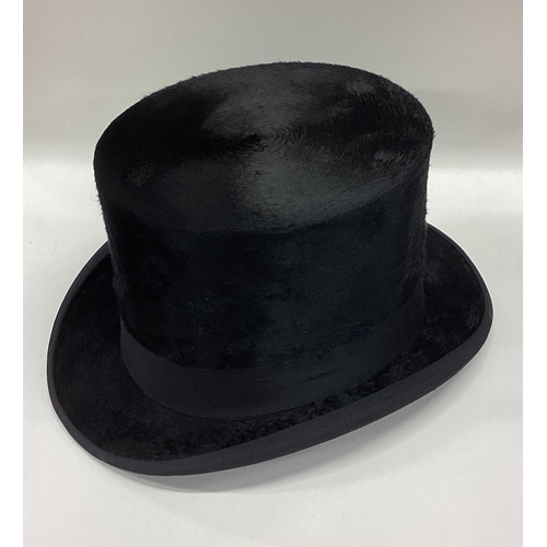 A boxed top hat and gloves with hinged lid. Est. £30 - £50.