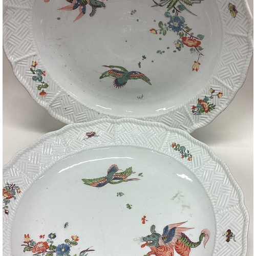 649 - A large pair of pottery chargers with bird decoration. Est. £20 - £30.