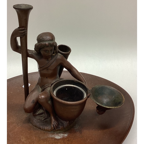 652 - A heavy bronze inkwell in the form of a figure. Est. £30 - £50.