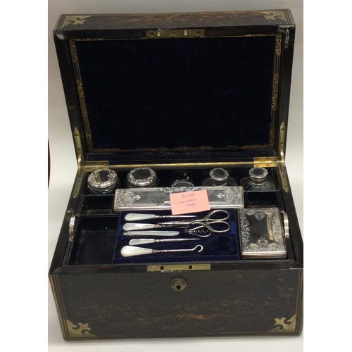 695 - A fine quality silver mounted travelling vanity case attractively decorated with engraving. London. ... 