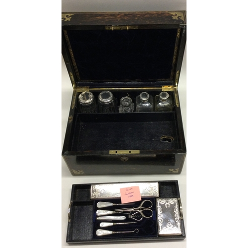 695 - A fine quality silver mounted travelling vanity case attractively decorated with engraving. London. ... 