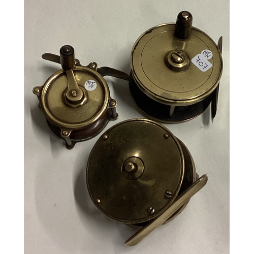 707 - Three Antique brass fly fishing reels. Est. £30 - £50.