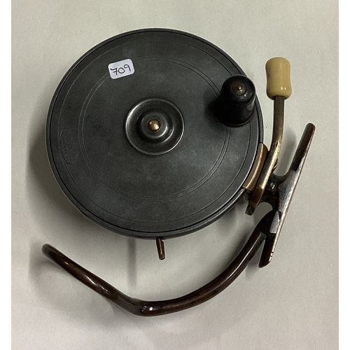 709 - MALLOCH: A large brass mounted fly fishing reel. Est. £30 - £50.