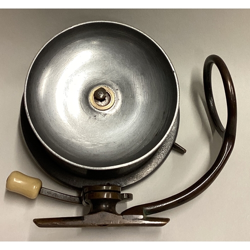 709 - MALLOCH: A large brass mounted fly fishing reel. Est. £30 - £50.