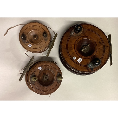 710 - Three wooden mounted fishing reels. Est. £30 - £40.