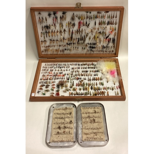 711 - A boxed collection of fishing flies. Est. £20 - £30.