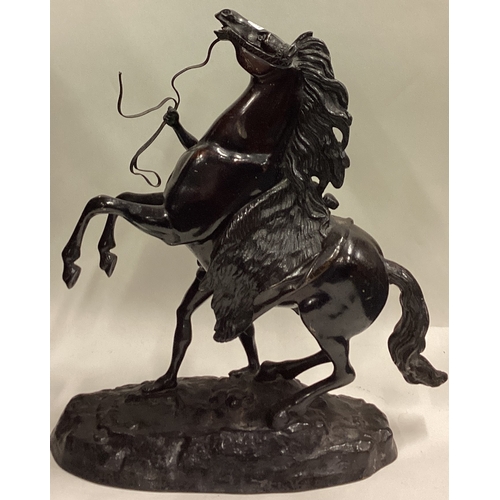 719 - A good pair of large bronze figures of horses on rugged landscape. Signed to base. Est. £100 - £200.