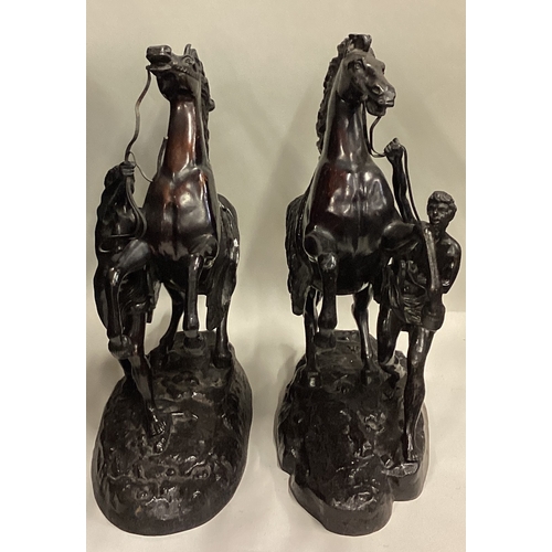 719 - A good pair of large bronze figures of horses on rugged landscape. Signed to base. Est. £100 - £200.