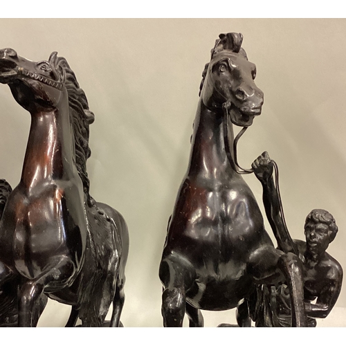 719 - A good pair of large bronze figures of horses on rugged landscape. Signed to base. Est. £100 - £200.