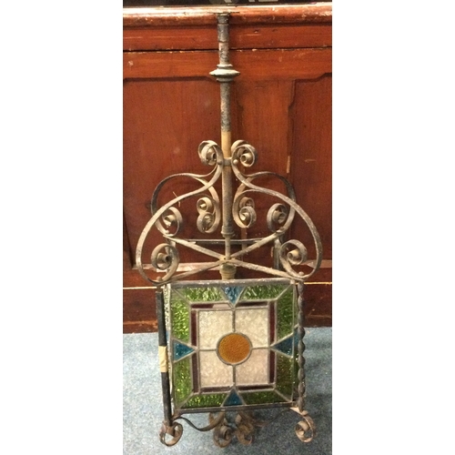 723 - A wrought iron and stained glass lamp. Est. £40 - £50.