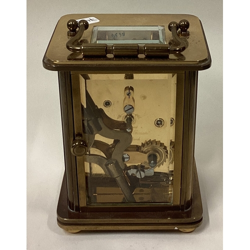 743 - A small brass carriage clock with white enamelled dial. Est. £30 - £40.