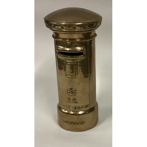 744 - A small brass money box in the form of a post box. Est. £40 - £60.