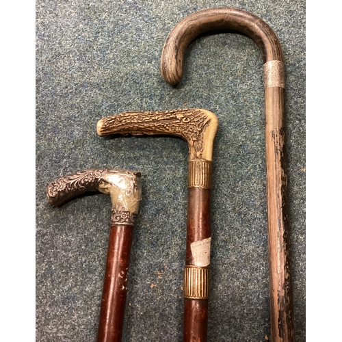 747 - Three silver mounted walking sticks. Est. £20 - £30.