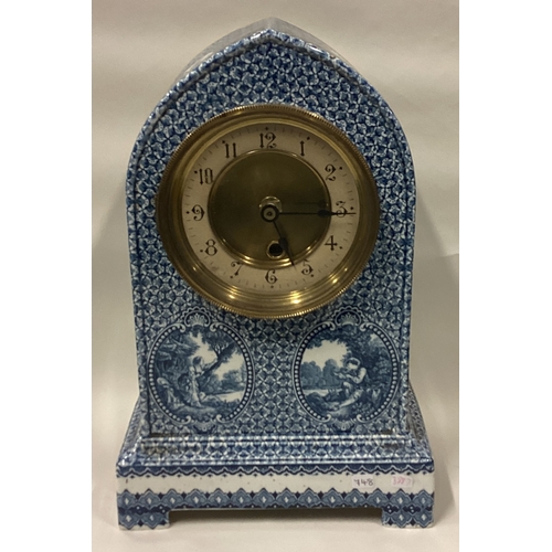 748 - An unusual blue and white wall clock. Est. £20 - £30.