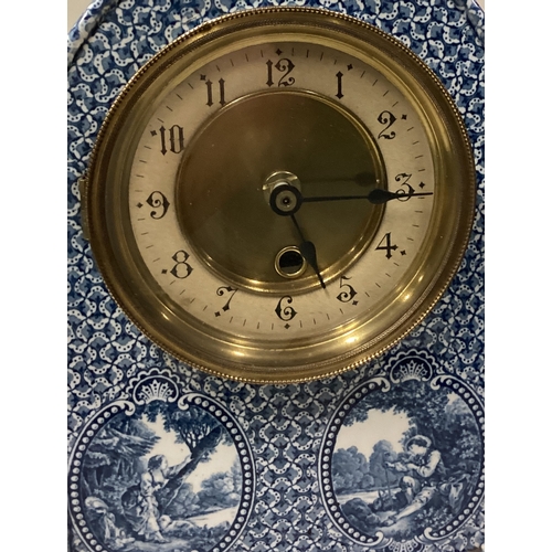 748 - An unusual blue and white wall clock. Est. £20 - £30.