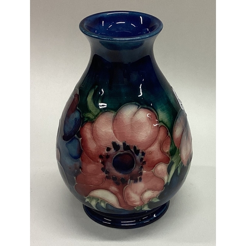 778 - WILLIAM MOORCROFT: A small pottery vase decorated with flowers. Est. £30 - £50.