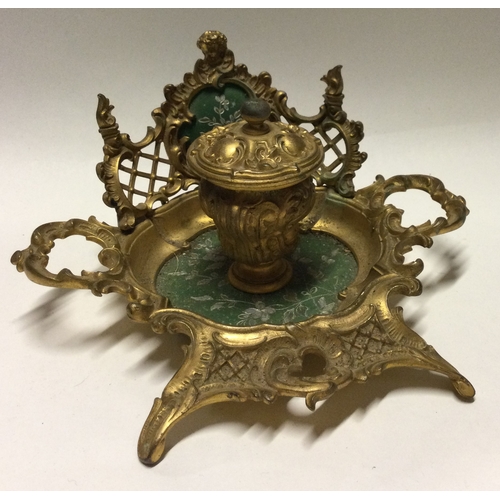 792 - An attractive brass mounted ink stand with scroll decocation. Est. £30 - £50.