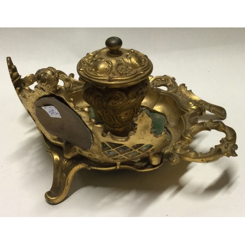 792 - An attractive brass mounted ink stand with scroll decocation. Est. £30 - £50.