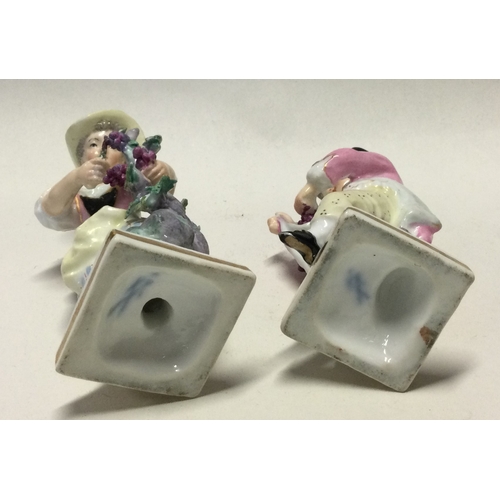 796 - MEISSEN: A pair of decorative porcelain figures in bright colours. Est. £30 - £50.