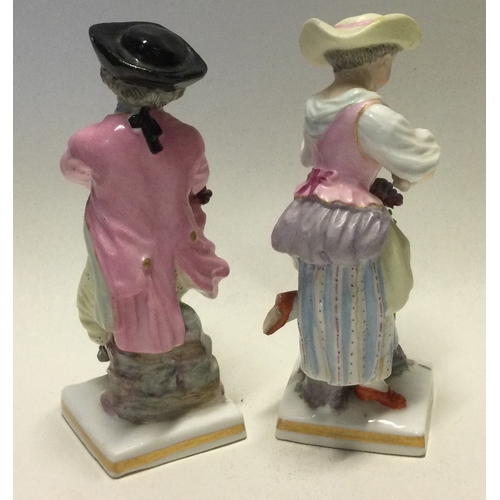 796 - MEISSEN: A pair of decorative porcelain figures in bright colours. Est. £30 - £50.