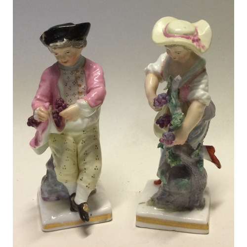 796 - MEISSEN: A pair of decorative porcelain figures in bright colours. Est. £30 - £50.