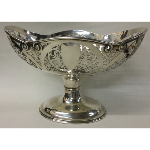 80A - An attractive pierced silver basket decorated with flowers and leaves. London. By Goldsmiths and Sil... 