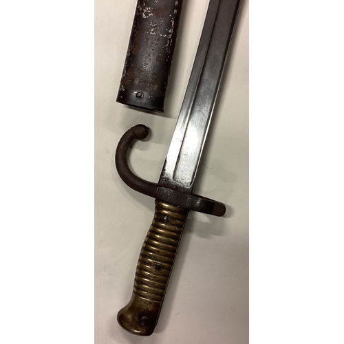 801 - A brass mounted bayonet with sheath. Est. £30 - £40.