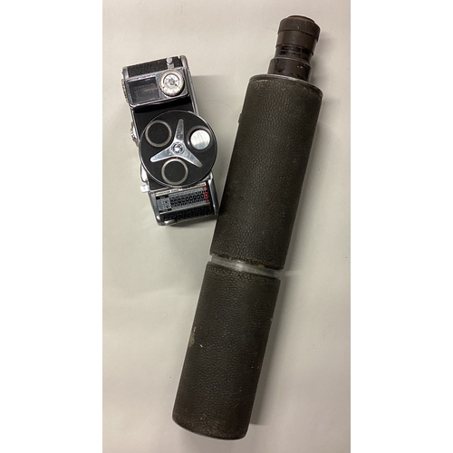 809 - An old sniper's observing telescope together with a camera. Est. £30 - £50.