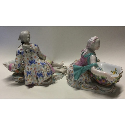 828 - MEISSEN: An attractive pair of porcelain dishes decorated with figurers in a recumbent position. Est... 