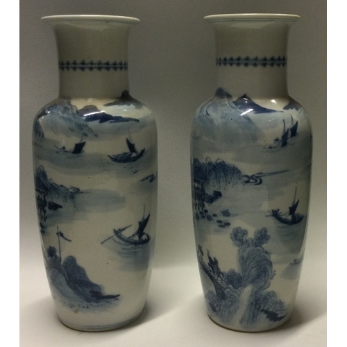 836 - A good pair of Chinese blue and white vases decorated with buildings. Kangxi mark to base. Approx. 2... 