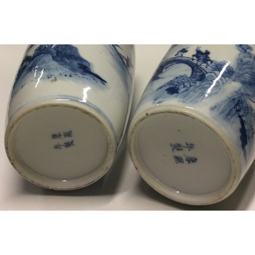 836 - A good pair of Chinese blue and white vases decorated with buildings. Kangxi mark to base. Approx. 2... 