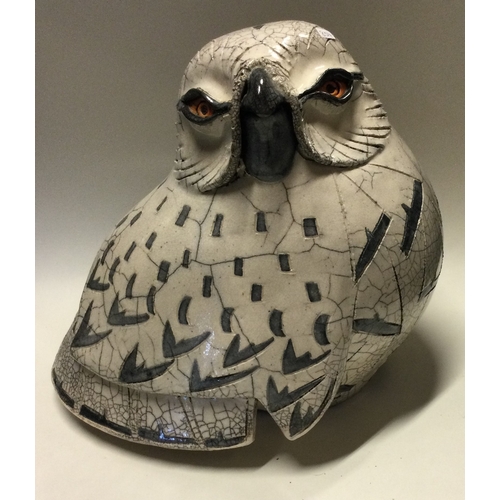 854 - JENNY HALE: A large pottery model of a snowy owl of stylised form. Est. £100 - £200.