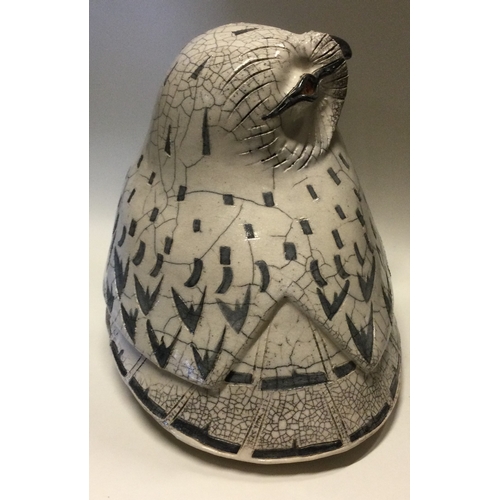 854 - JENNY HALE: A large pottery model of a snowy owl of stylised form. Est. £100 - £200.