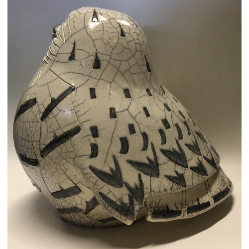 854 - JENNY HALE: A large pottery model of a snowy owl of stylised form. Est. £100 - £200.